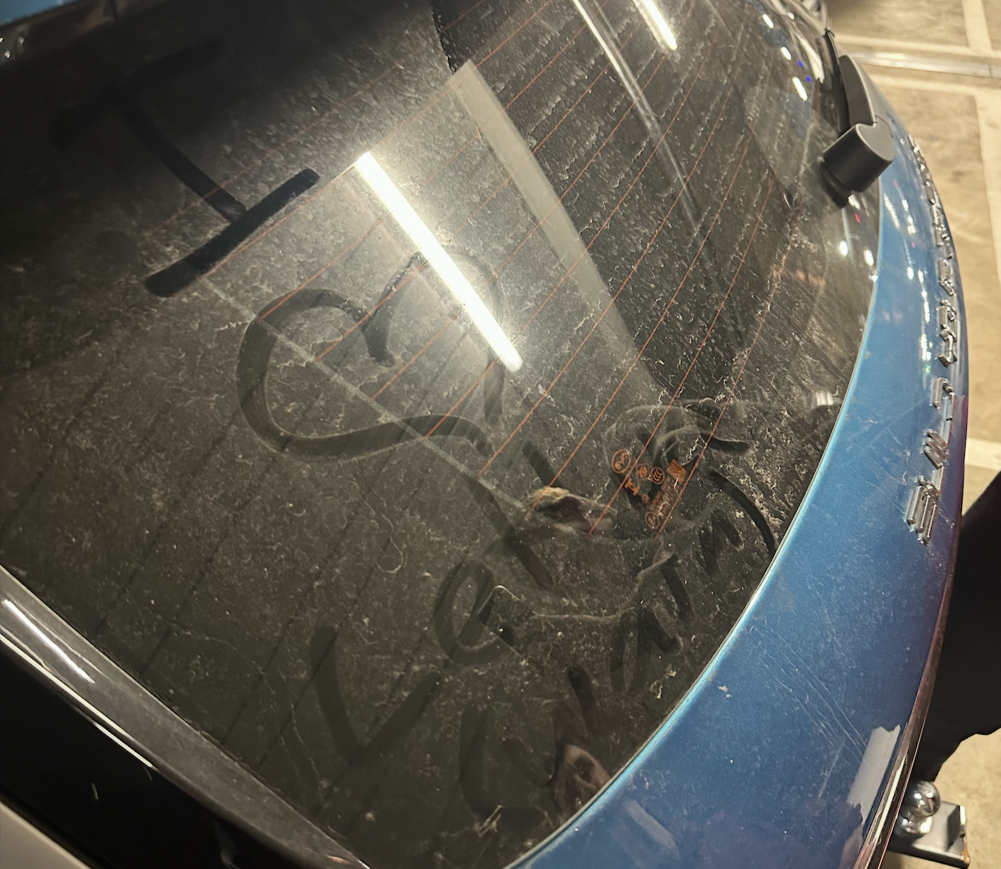 Car windshield with 'I love lettuce (warm)'' written on it